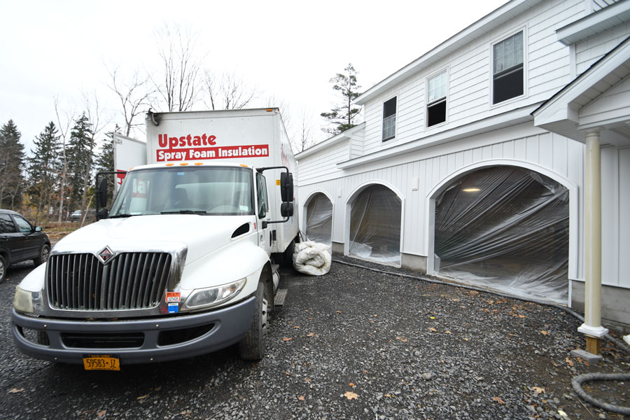 Exterior of new construction garage/in-law apartment with Upstate Spray Foam truck nearby during insulation installation