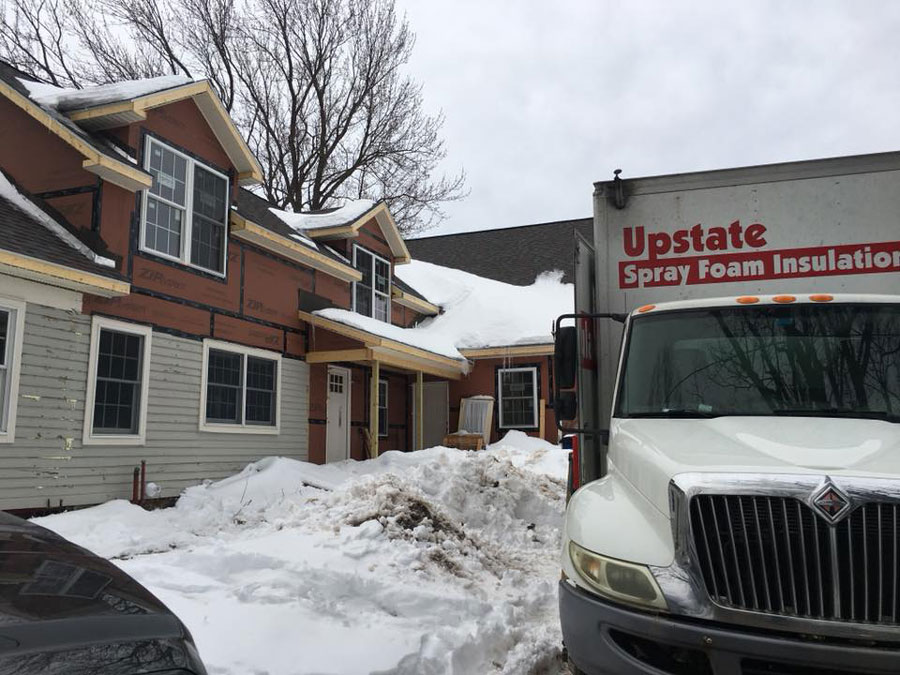 Exterior of home being remodeled with insulation and new siding being applied