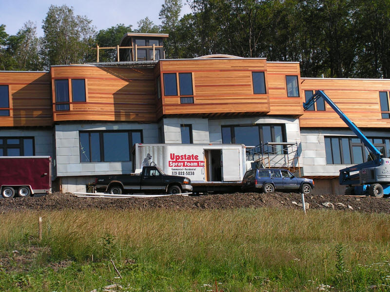 Alternative view of exterior of large residential unit new construction project during insulation installation