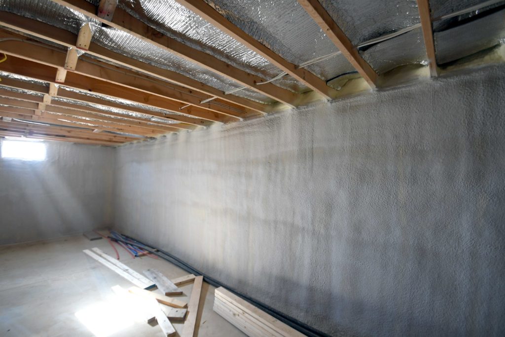 Short basement walls insulated with closed cell spray foam in clean installation