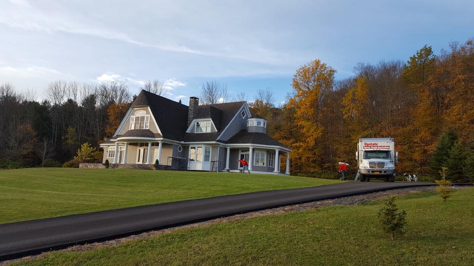 Upstate Spray Foam truck parked outside of existing home for insulation services